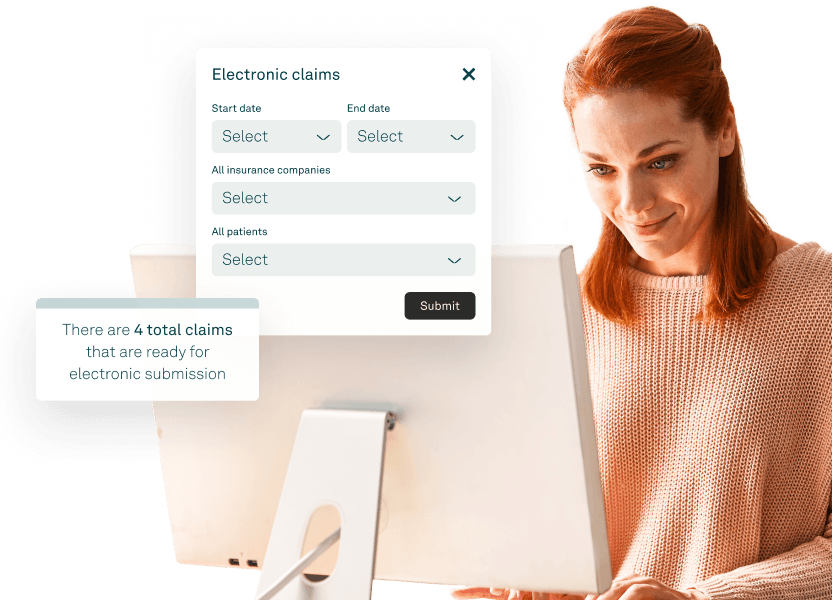 Healthcare staff reviewing insurance claims on a desktop using medical billing software.