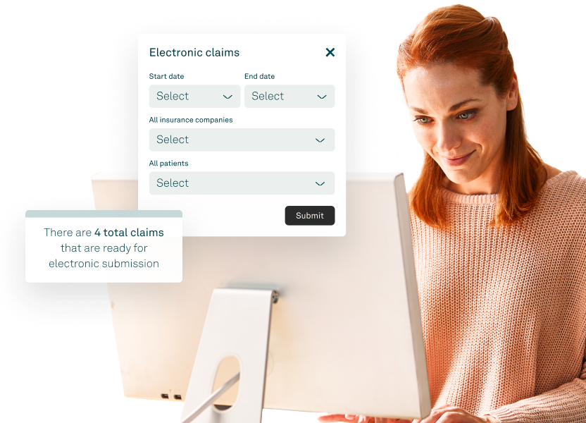 Healthcare staff reviewing insurance claims on a desktop using medical billing software.
